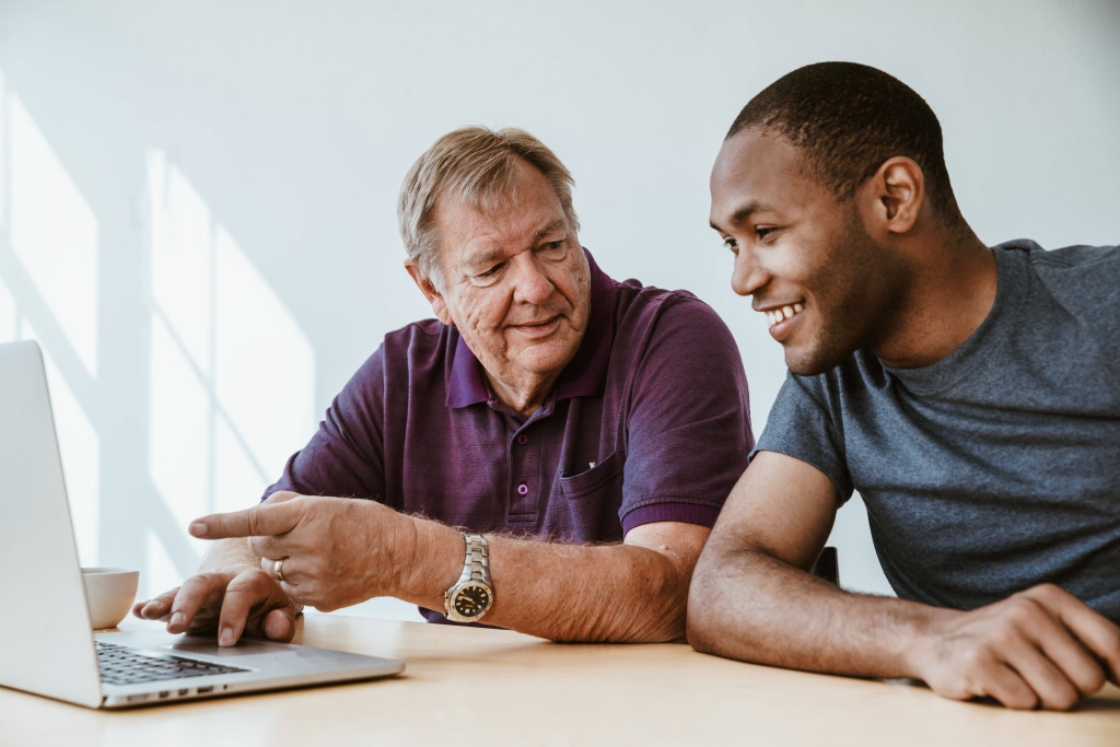 old white man and young black man having conversation